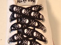 Skull Print Shoelaces On Chucks  Black and white skull print shoelace on an optical white low cut.