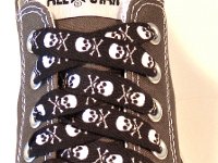 Skull Print Shoelaces On Chucks  Black and white skull print shoelace on a grey low cut.