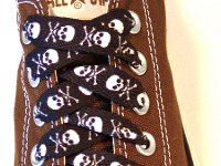 Skull Print Shoelaces On Chucks  Black and white skull print shoelace on a chocolate brown low cut.
