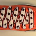 Star Print Shoelaces on Chucks  Orange high top chuck with black, white and red star print shoelaces.
