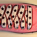 Star Print Shoelaces on Chucks  Pink low top chuck with black, white and red star print shoelaces.