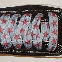 Star Print Shoelaces on Chucks  Black low top chuck with red and silver star print shoelaces.