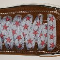 Star Print Shoelaces on Chucks  Chocolate brown low top chuck with red and silver star print shoelaces.