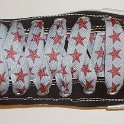 Star Print Shoelaces on Chucks  Black high top chuck with red and silver star print shoelaces.