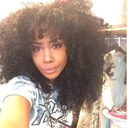 SZA  SZA takes a selfie with a pair of red chucks in the background.