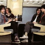 The Strokes  Seated in a club car.