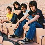 The Strokes  Seated in an empty stadium. Julian showing off his black high tops.