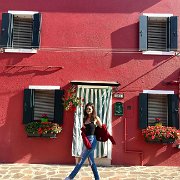 Victoria Justice  Carefree amongst the colorful buildings in her white chucks.