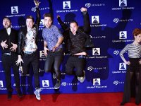 Walk the Moon  Rock band Walk The Moon jumps for photographers as violinist Lindsey Stirling, right, poses on the red carpet at the 17th Annual GRAMMY Foundation Legacy Concert at the Wilshire Ebell Theatre on Thursday, Feb. 5, 2015, in Los Angeles. (Photo by Chris Pizzello/Invision/AP)