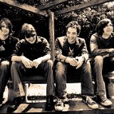 The Wallflowers  Publicity photo with three members wearing black high top chucks.