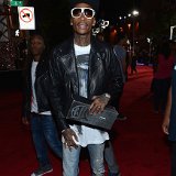 Wiz Khalifa  Wiz Khalifa wearing red high tops from his own collection of designer chucks.