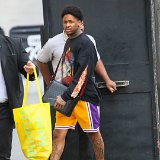 YG  YG wearing yellow low top chucks with Laker shirts, showing his LA pride.