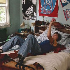 Young Sheldon  Georgie (Montana Jordan) lying on his bed.