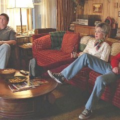 Young Sheldon  Georgie seated in the living room with his parents.