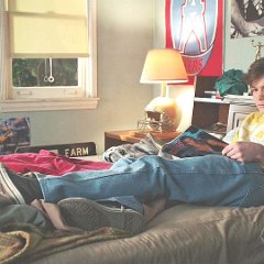 Young Sheldon  Georgie reading a magazine in his room.